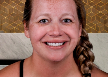 Happy patient at Xdentistry standing out her new smile