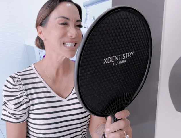 Patient looking her new smile at Xdentistry